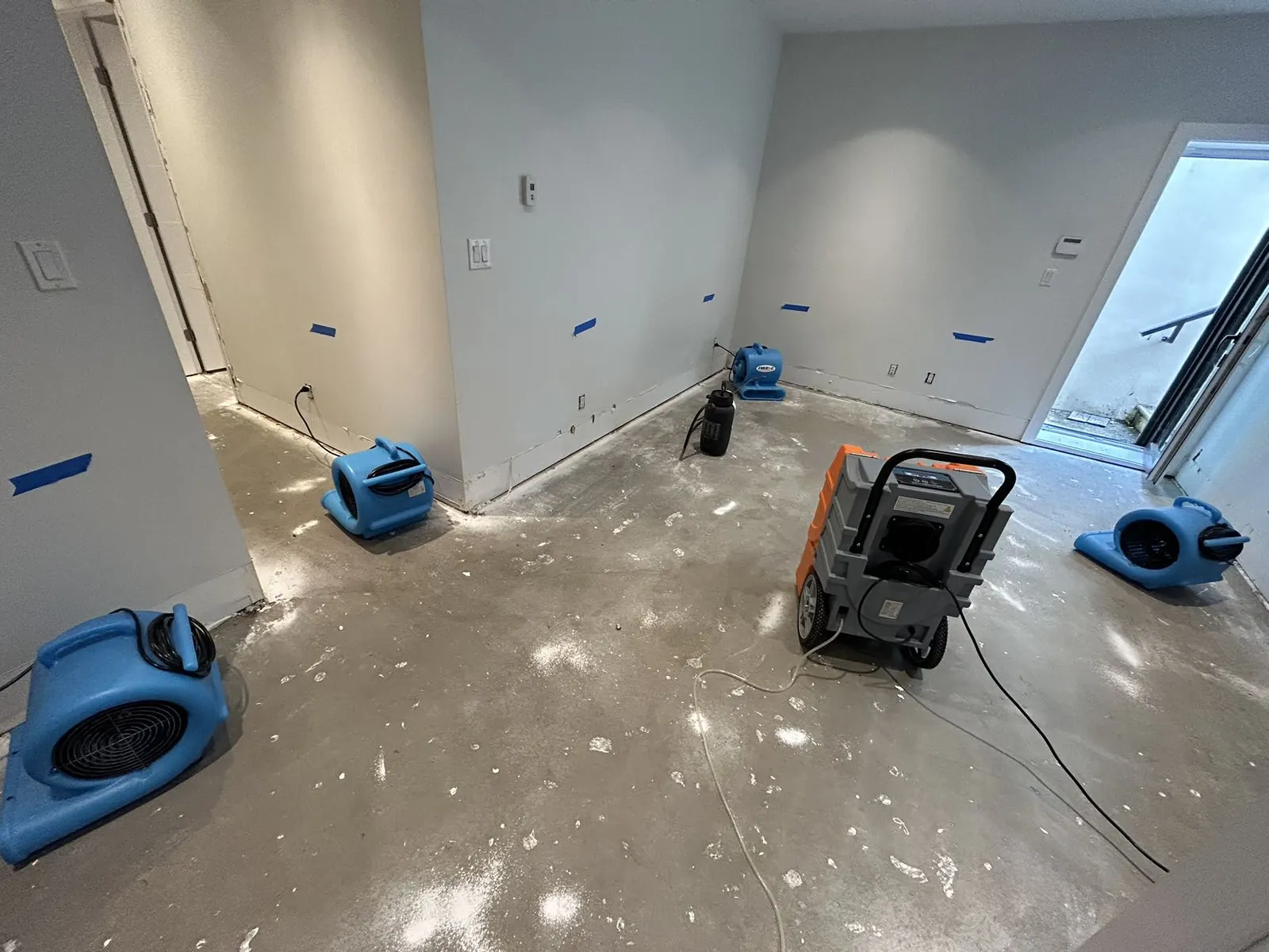 Air movers drying a room after water damage
