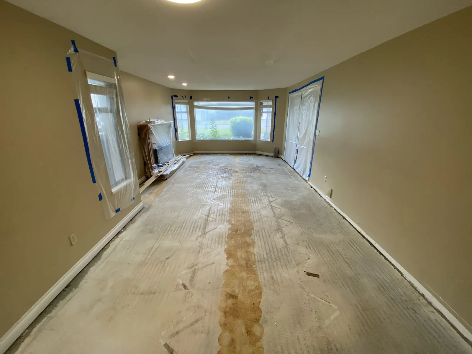 Hallway with flooring removed during restoration, ready for rebuild